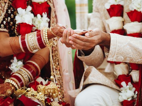 Hands of indian bride and groom intertwined together making authentic wedding ritual